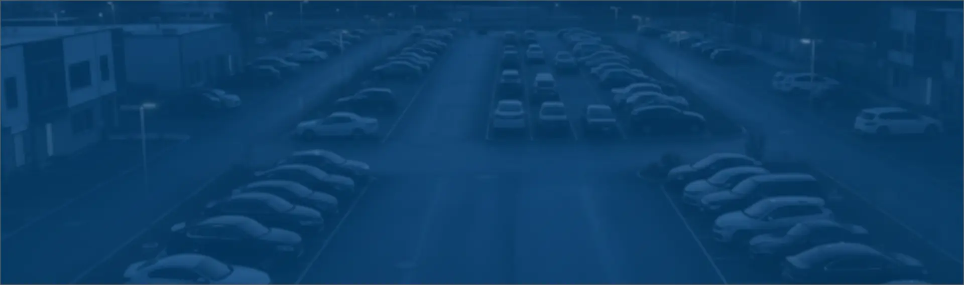 High-angle view of a large organized parking lot managed by the ParkEase parking app, showcasing efficient space utilization and professional vehicle oversight.